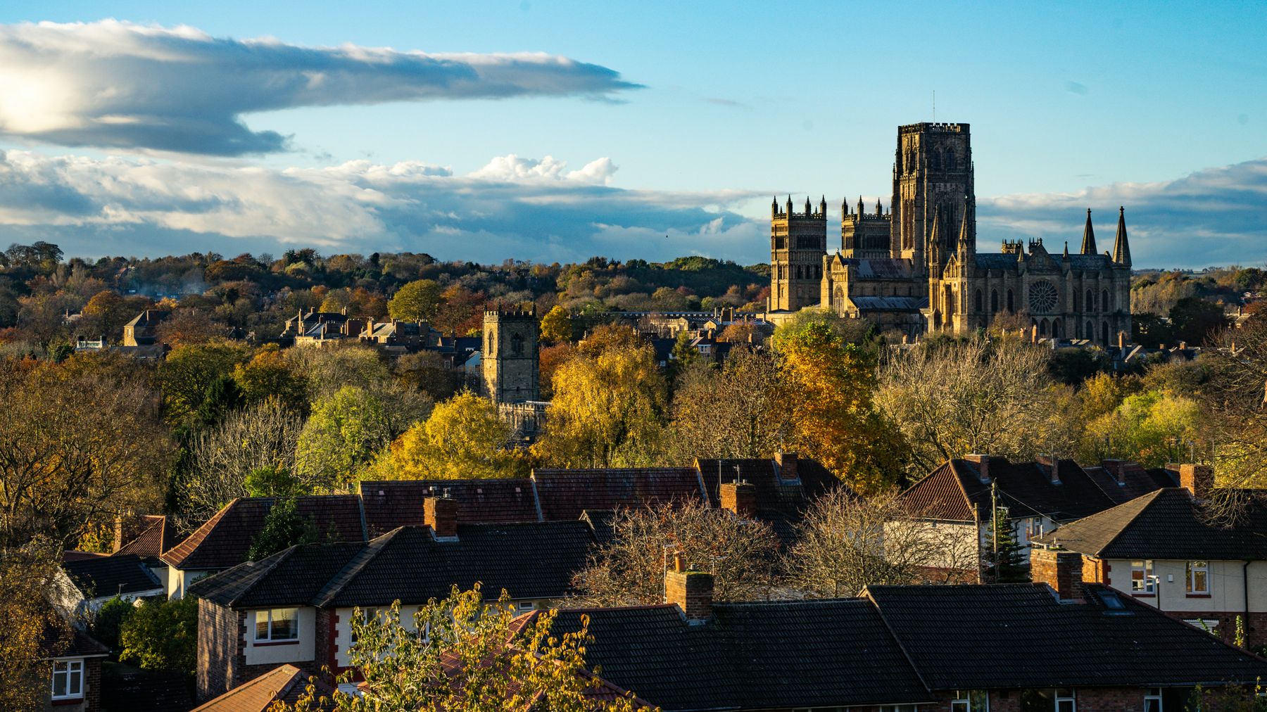Durham Cathedral rising above the city's rooftops in autumn light